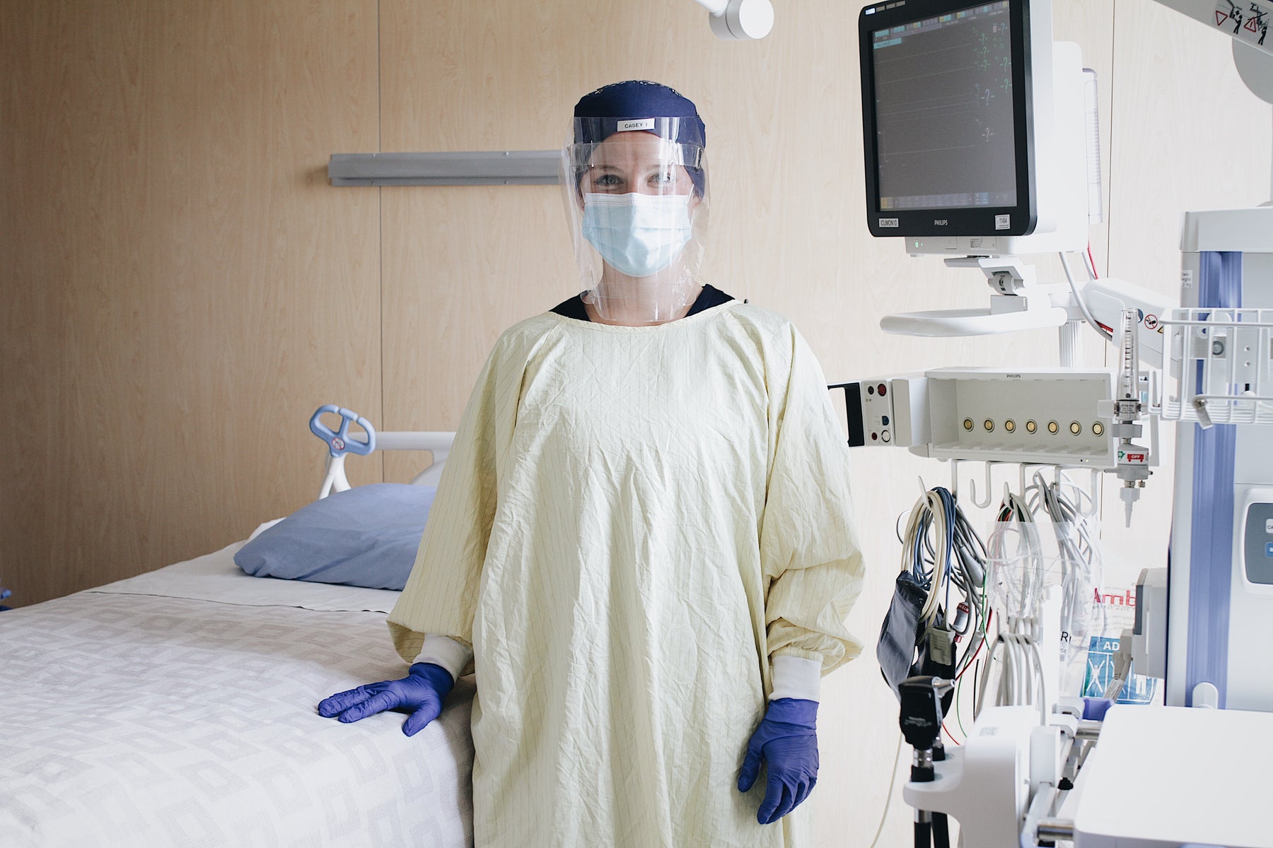 Healthcare worker wearing PPE face shield and procedural mask